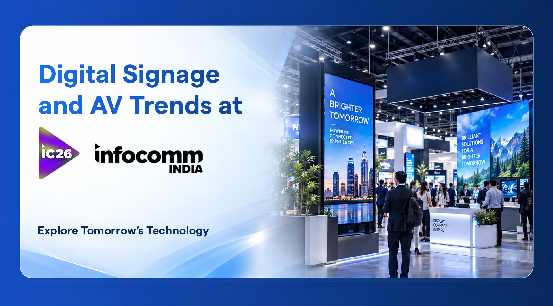 Tall digital signage displays on the InfoComm India 2026 show floor with visitors walking between exhibition stands